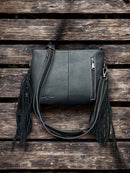 This Black tooled leather and cowhide purse features a removable adjustable shoulder strap and zippered close concealed carry pocket on the rear. Rear View 