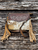 This Brown tooled leather and cowhide purse features a removable adjustable shoulder strap and a zippered closed concealed carry pocket on the rear. Inside it has six card slots and a zippered closed pocket. Front View C