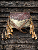 This Brown tooled leather and cowhide purse features a removable adjustable shoulder strap and a zippered closed concealed carry pocket on the rear. Inside it has six card slots and a zippered closed pocket. Front View D