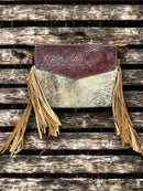 This Brown tooled leather and cowhide purse features a removable adjustable shoulder strap and a zippered closed concealed carry pocket on the rear. Inside it has six card slots and a zippered closed pocket. Front View E