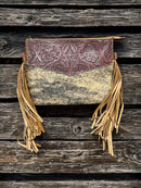 This Brown tooled leather and cowhide purse features a removable adjustable shoulder strap and a zippered closed concealed carry pocket on the rear. Inside it has six card slots and a zippered closed pocket. Front View F