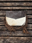 This Brown tooled leather and cowhide purse features a removable adjustable shoulder strap and a zippered closed concealed carry pocket on the rear. Inside it has six card slots and a zippered closed pocket. Front View B