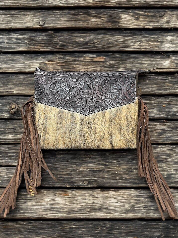 This Brown tooled leather and cowhide purse features a removable adjustable shoulder strap and a zippered closed concealed carry pocket on the rear. Inside it has six card slots and a zippered closed pocket. Front View C