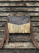 This Brown tooled leather and cowhide purse features a removable adjustable shoulder strap and a zippered closed concealed carry pocket on the rear. Inside it has six card slots and a zippered closed pocket. Front View C