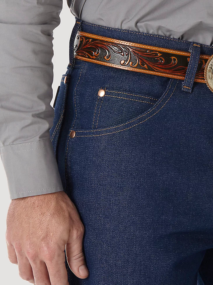Closeup of front right scoop pocket of a man wearing Wrangler® Cowboy Cut®  relaxed fit rigid blue jeans with western shirt. Pocket has copper rivets on top corners and a coin pocket.