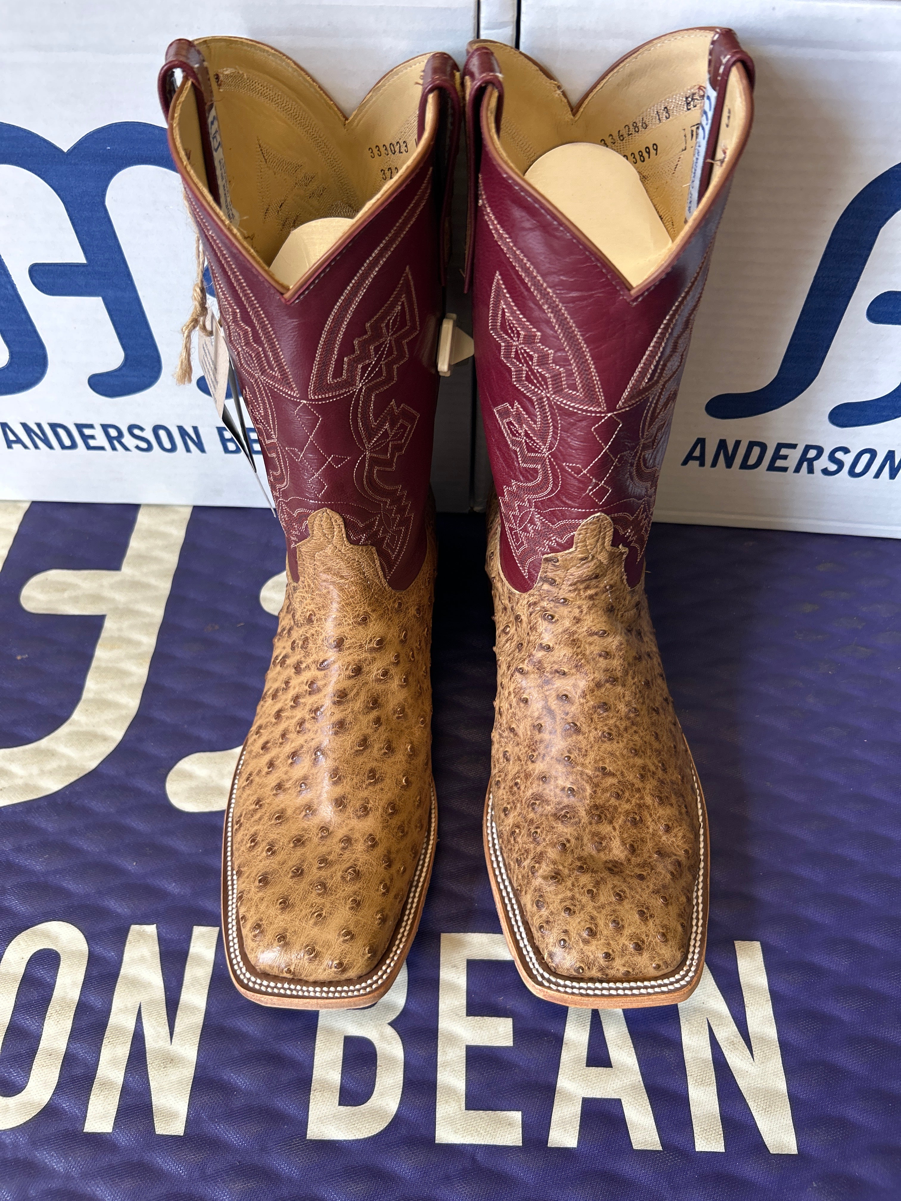 Pair of brown cowboy boots on a blue Anderson Bean background
