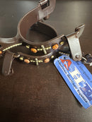 Women's spurs featuring copper and brass accents including a cross. 