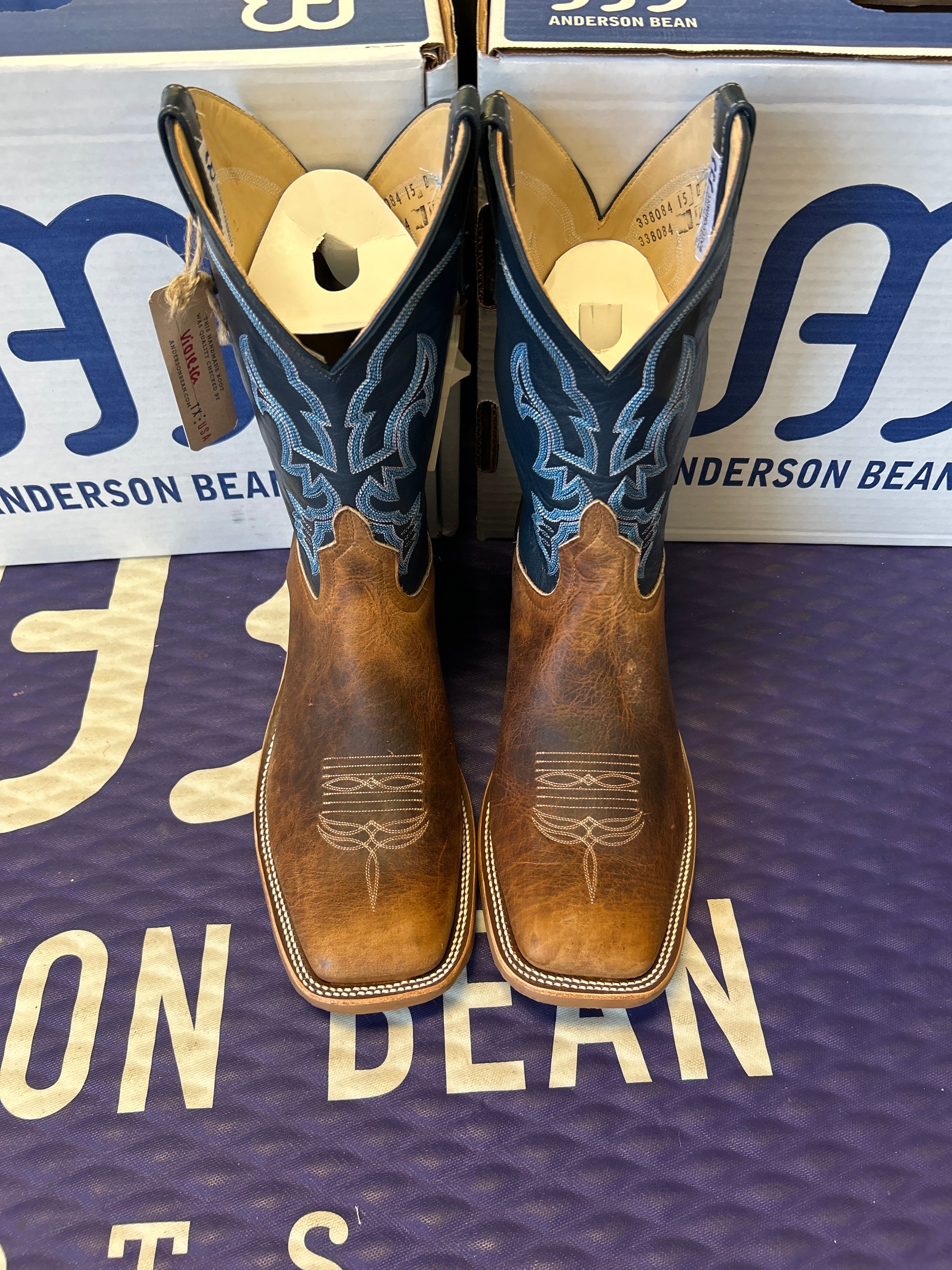 Pair of cowboy boots on a Anderson Bean branded surface