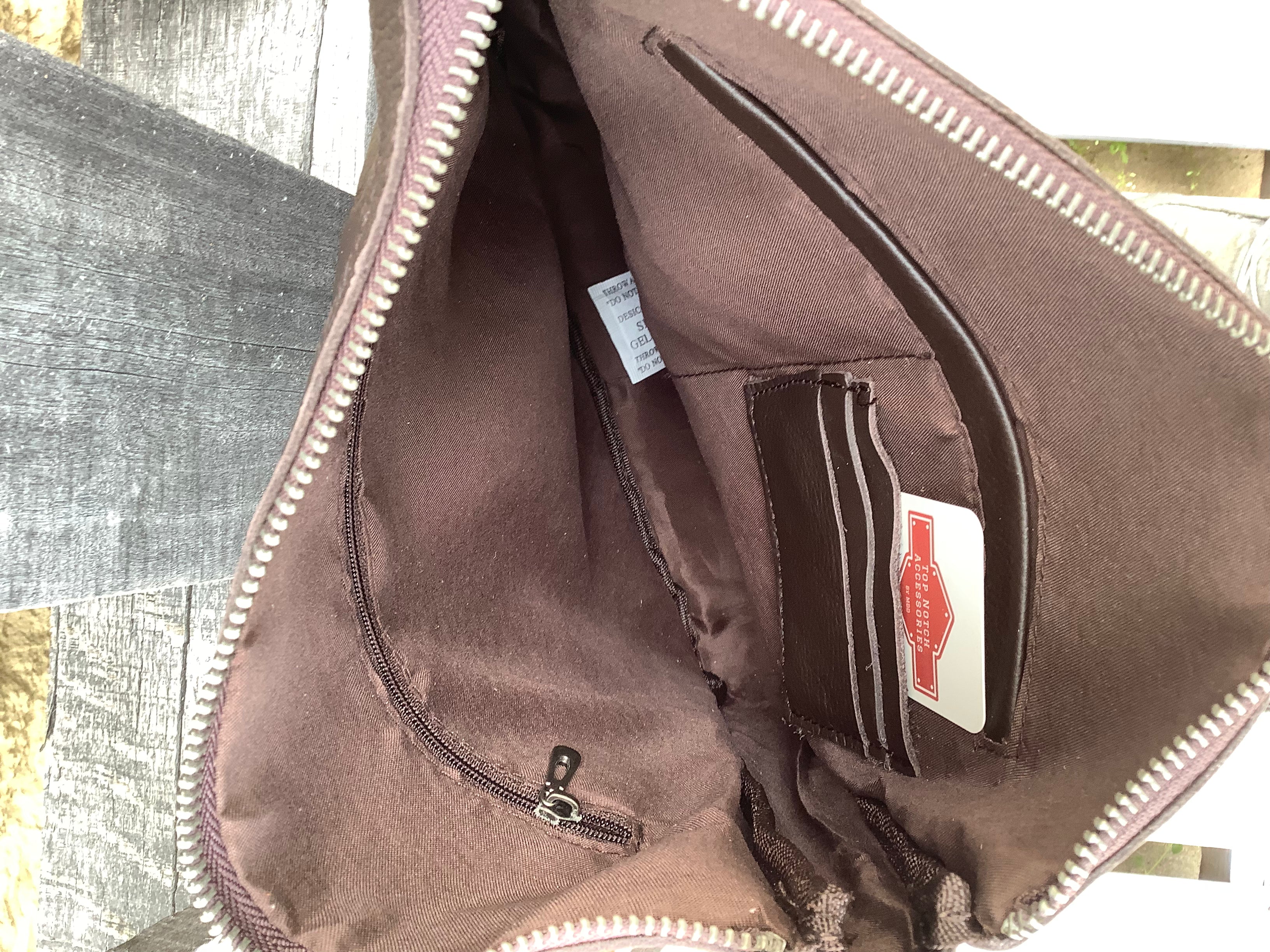 Cowhide and Coffee Brown leather crossbody bag with a tooled leather design on top. This bag features side fringe and a concealed carry pocket on the rear. Inside view showing zippered pocket and three credit card slots. 