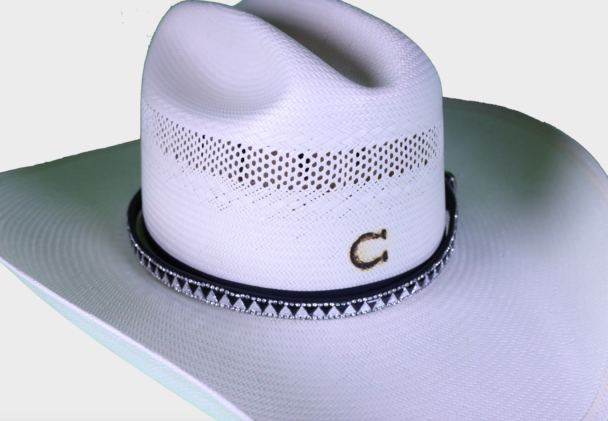 Black leather hat band with triangle crystals. Shown on a straw hat. 