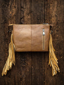 This Brown tooled leather and cowhide purse features a removable adjustable shoulder strap and a zippered closed concealed carry pocket on the rear. Inside it has six card slots and a zippered closed pocket. Rear View