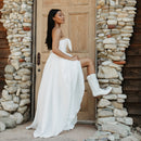 A life style photo of a women wearing a pair of white smooth leather women's Dingo boot with a snip toe and a western heel.