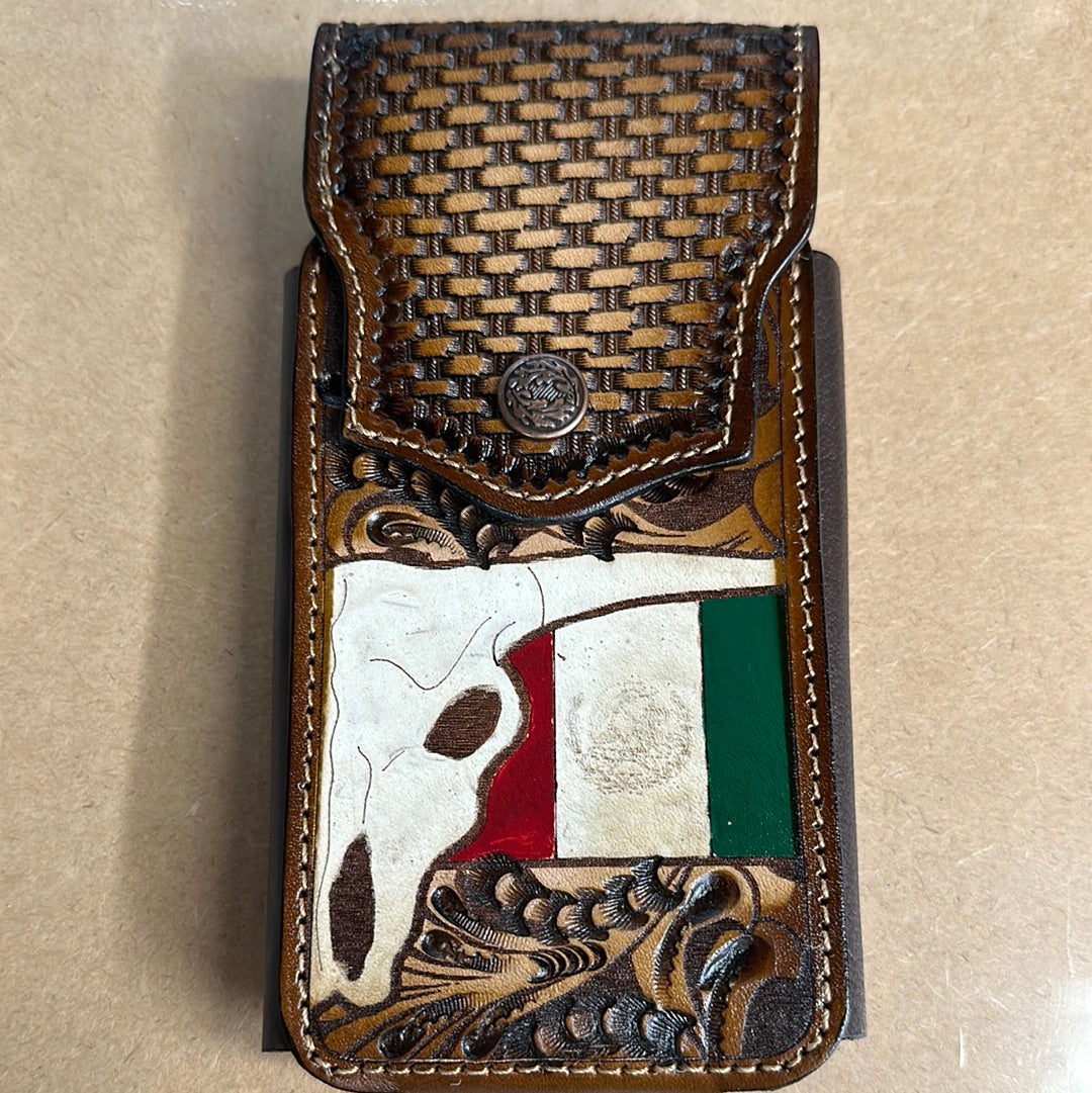 This leather phone case has a intricate design featuring the Flag of Mexico and a Steer Skull. It has a snap closure and a leather belt loop for attachment. This case measures 7 1/4 inches tall, and 3 5/8 inches wide empty.