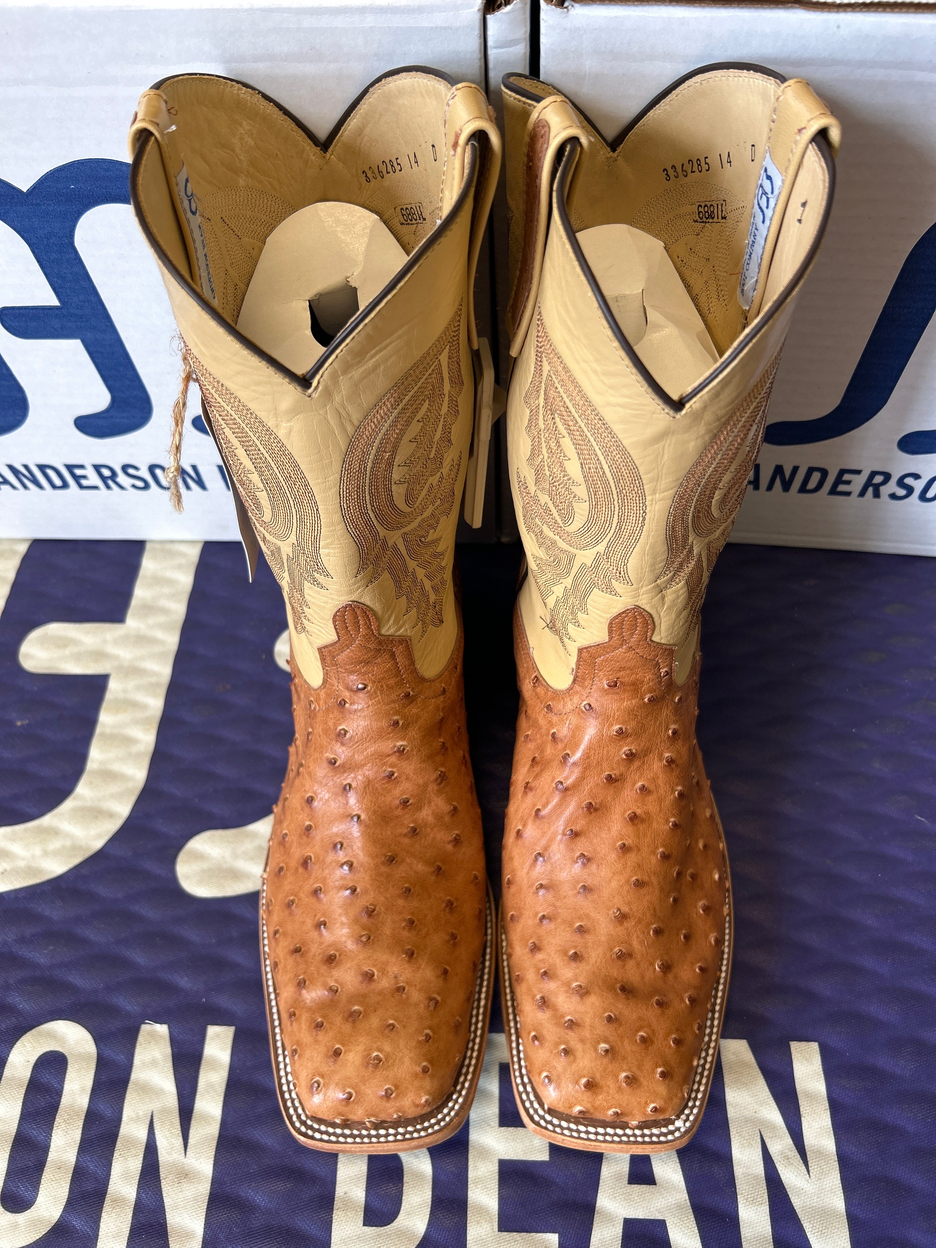 Pair of brown cowboy boots on a blue Andersons branded box.