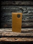 This Brown leather tall wallet features a Shotgun Shell Concho. Front View