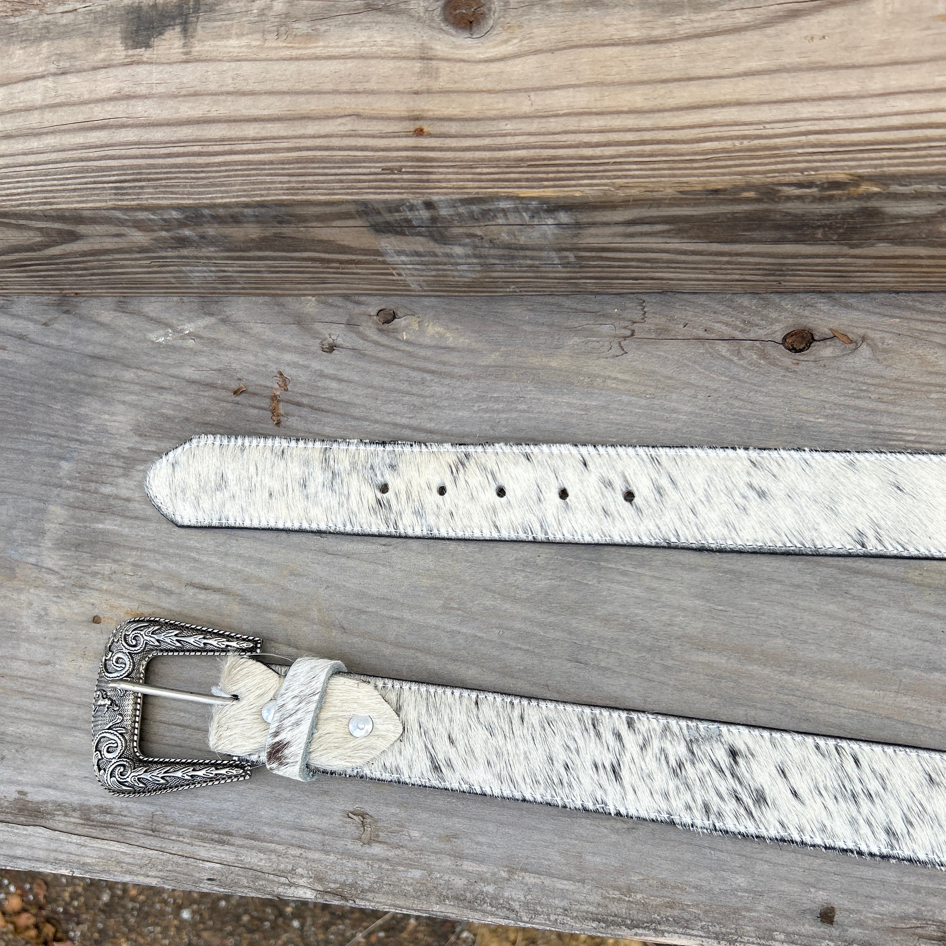 This Cowhide western style belt features a buckle with a intricate design featuring a horse. 44 A