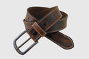 A tan and brown distressed leather belt with a removable antique brass buckle.
