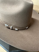 Side view featuring hand band buckle felt cowboy hat in Tuscan. 