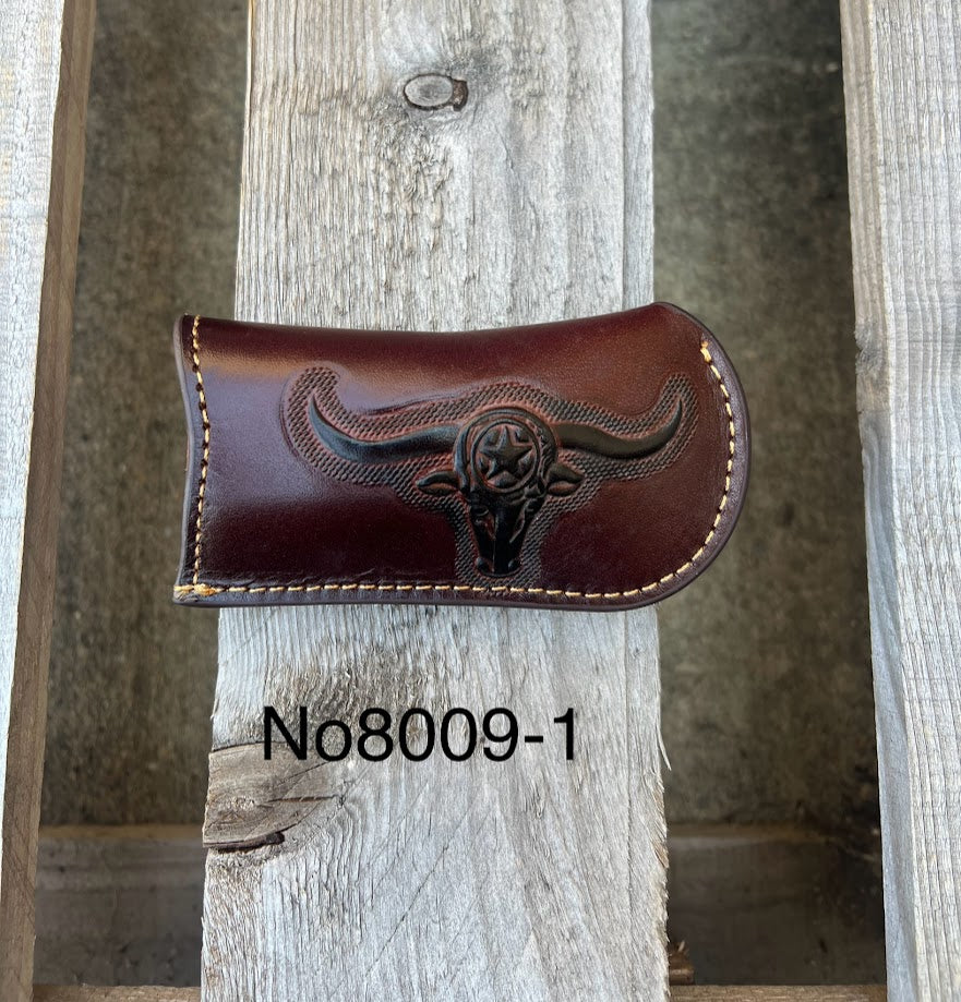 A Coffee Brown leather knife sheath with a embossed Longhorn and Star design. Front View