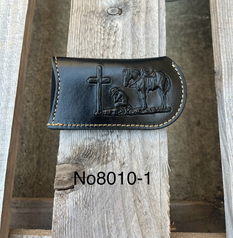 This Black leather knife sheath from Top Notch Accessories features an embossed Praying Cowboy design. Front View