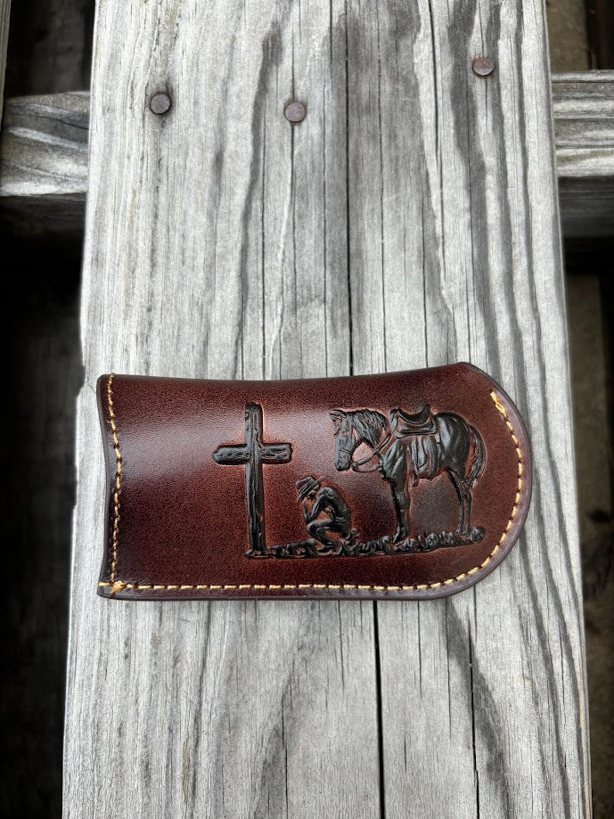 This Coffee Brown leather knife sheath from Top Notch Accessories features a embossed praying cowboy design. Front View