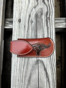 A brown leather knife sheath with a longhorn and star design. Front View