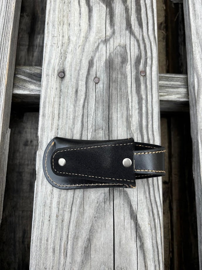This Black leather knife sheath by Top Notch Accessories features a embossed Praying Cowboy design and has a keep for closure. Rear view showing leather belt loop. 
