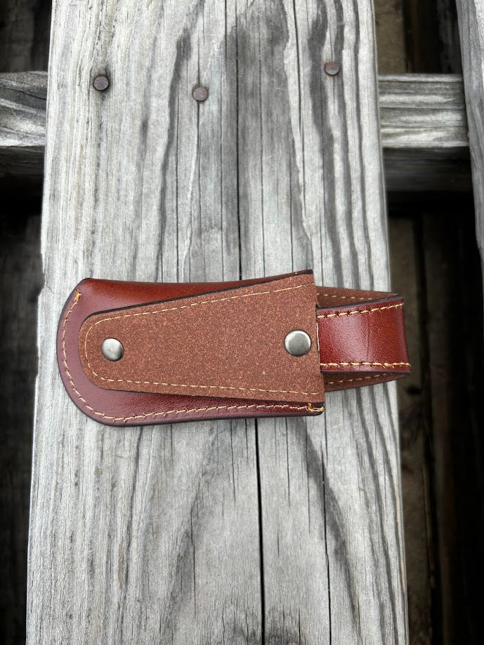 This Brown leather knife sheath with a Praying Cowboy design features a keep closure. Rear view showing the leather belt attachment. 