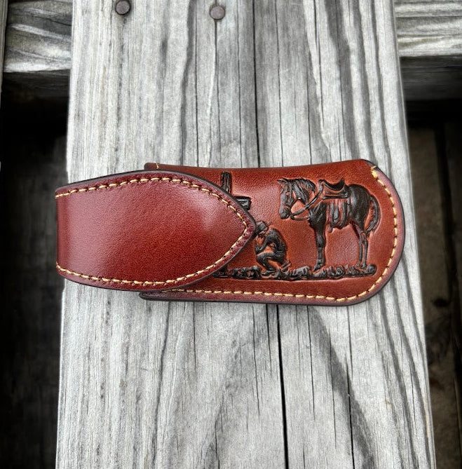 This Brown leather knife sheath with a Praying Cowboy design features a keep closure. 