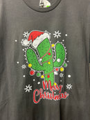 This gray  Bella Canvas t-shirt features a graphic print of a cactus wearing a Santa hat, surrounded by Christmas lights and the text 'Merry Christmas'.