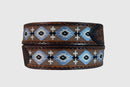 A brown leather belt with floral hand tooled end tabs and Aztec/cross embroidered designs.