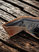 Brown alligator print leather trifold wallet with a Praying Cowboy Concho on a cowhide inlay.  Inside view showing cash slots with zippered closure.