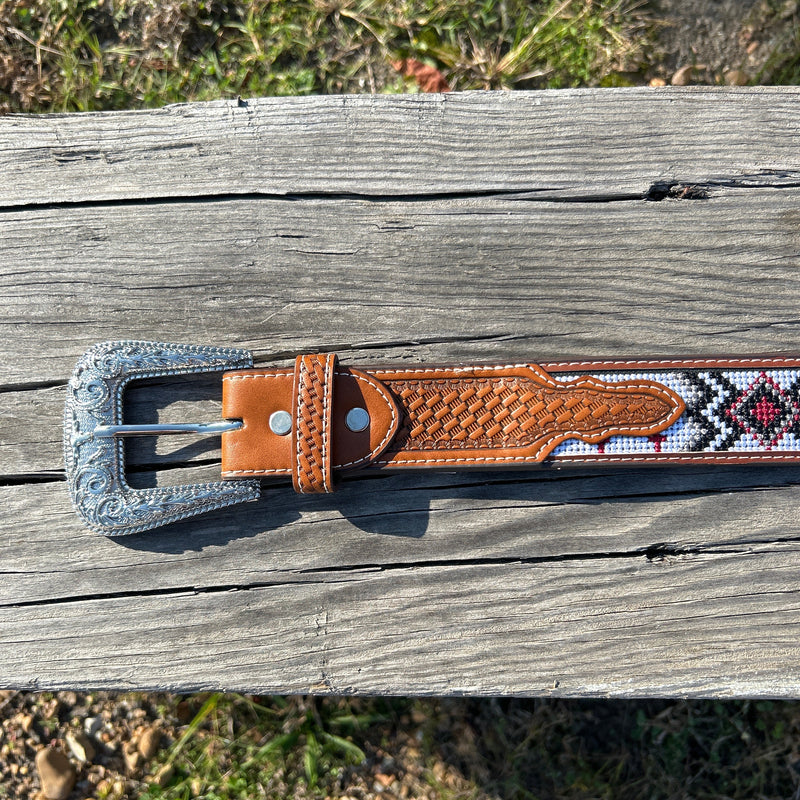 This Red Cross Design embroidered belt has basketweave leather overlay on each end. It has a Silver Western style buckle with a Longhorn design. Close up of buckle. 