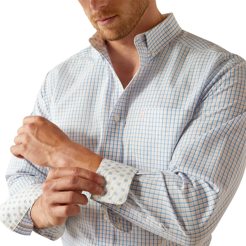Men's Ariat wrinkle free long sleeve shirt in Blue Plaid. Close up of contrast pattern on cuff and Ariat shield logo on left chest pocket. 