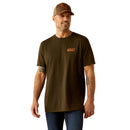 Men's Ariat short sleeve tee in Dark Olive with a armadillo graphic print on back. Front view showing Ariat logo on left chest and shirt untucked. 