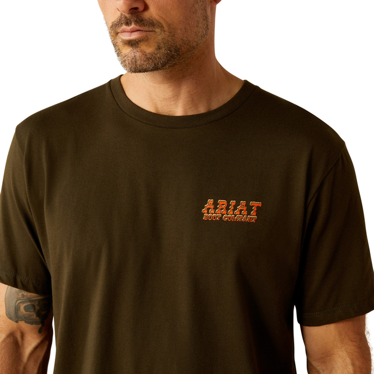 Men's Ariat short sleeve tee in Dark Olive with a armadillo graphic print on back. Front view showing close up of Ariat Boot Company graphic. 