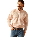 Men's Ariat long sleeve shirt in Pink with a small geometric print. Front view showing shirt tucked in. 
