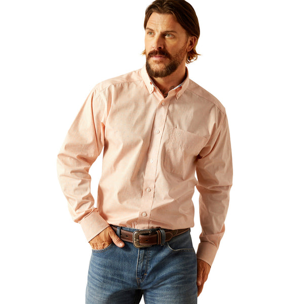 Men's Ariat long sleeve shirt in Pink with a small geometric print. Front view showing shirt tucked in. 
