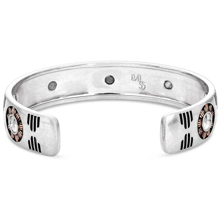 This Silver Cuff bracelet featuring a rose gold tone and deep black paint etched into a Southwestern pattern that continues around to the back of the bracelet. It also features three round howlite stones at the top of the cuff. Inside View 