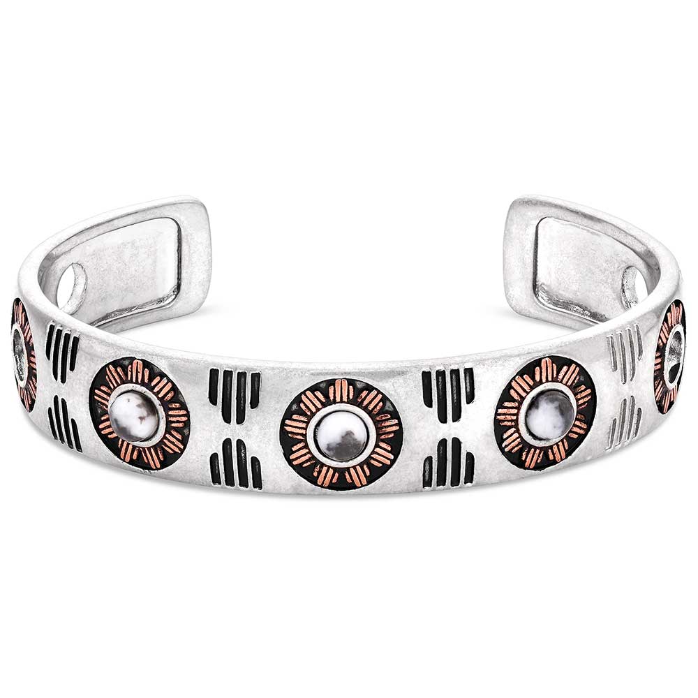 This Silver Cuff bracelet featuring a rose gold tone and deep black paint etched into a Southwestern pattern that continues around to the back of the bracelet. It also features three round howlite stones at the top of the cuff. Front View 