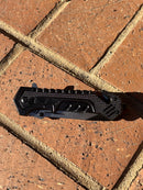 This black multi tool locking knife features a glass breaker and a rope cutter. Closed View