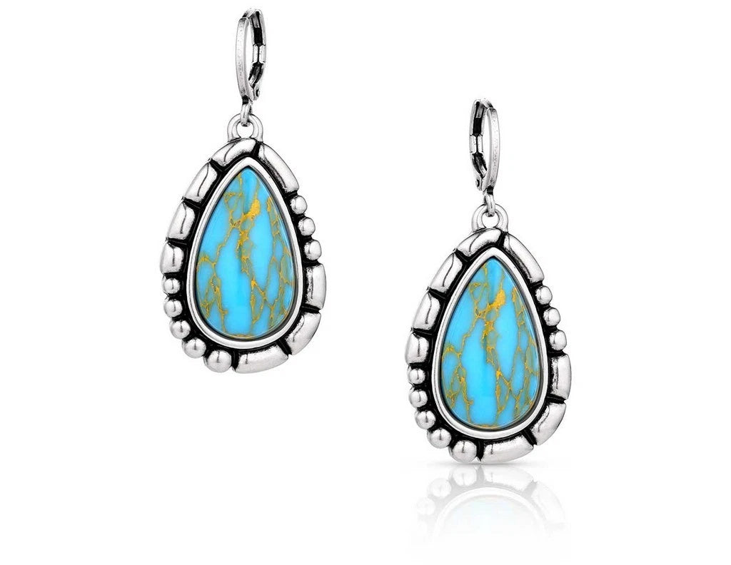 Crafted Turquoise teardrop earrings with silver border and a hinged clasp.  Front View 