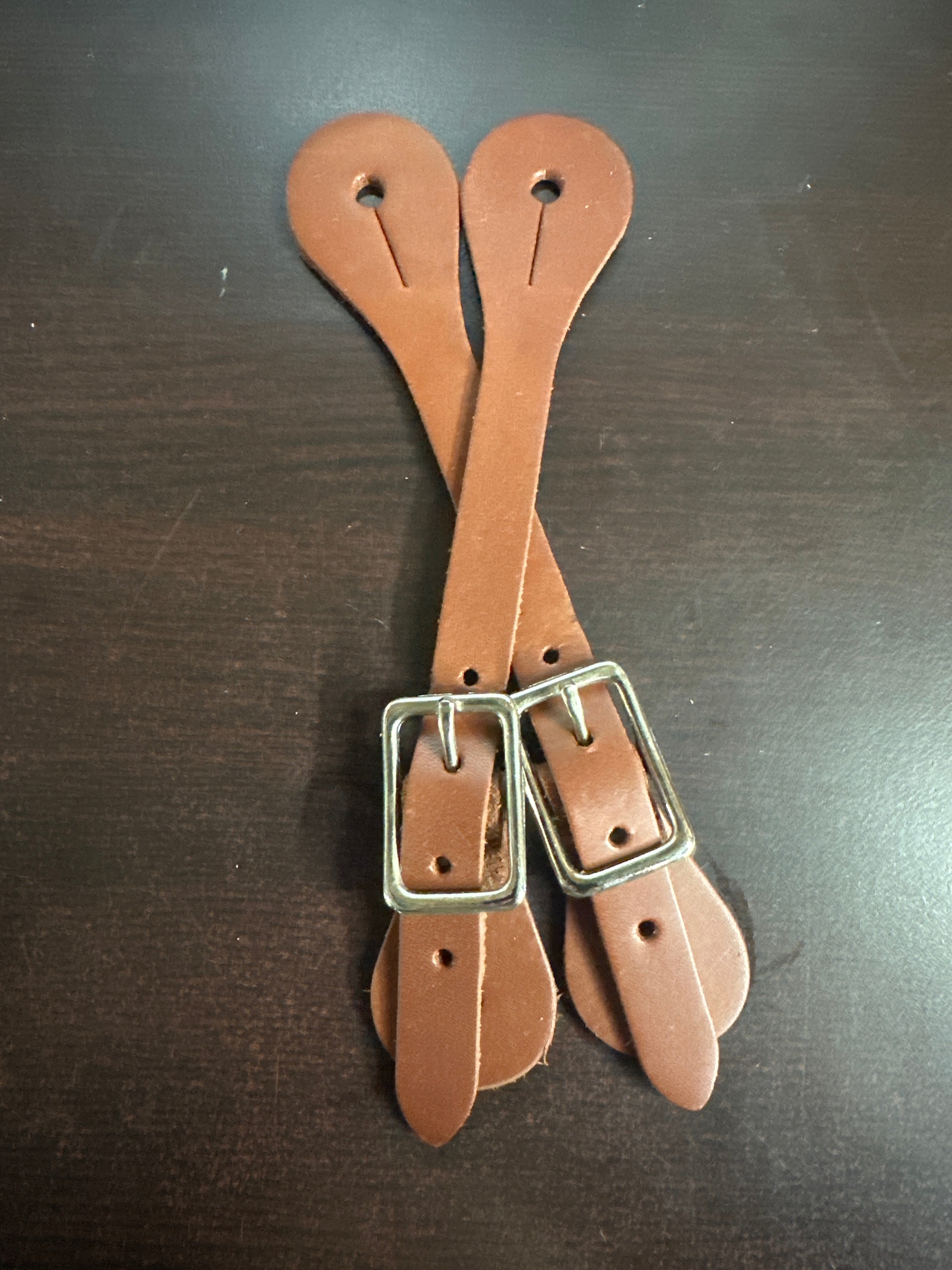 Brown oiled leather spur straps. 