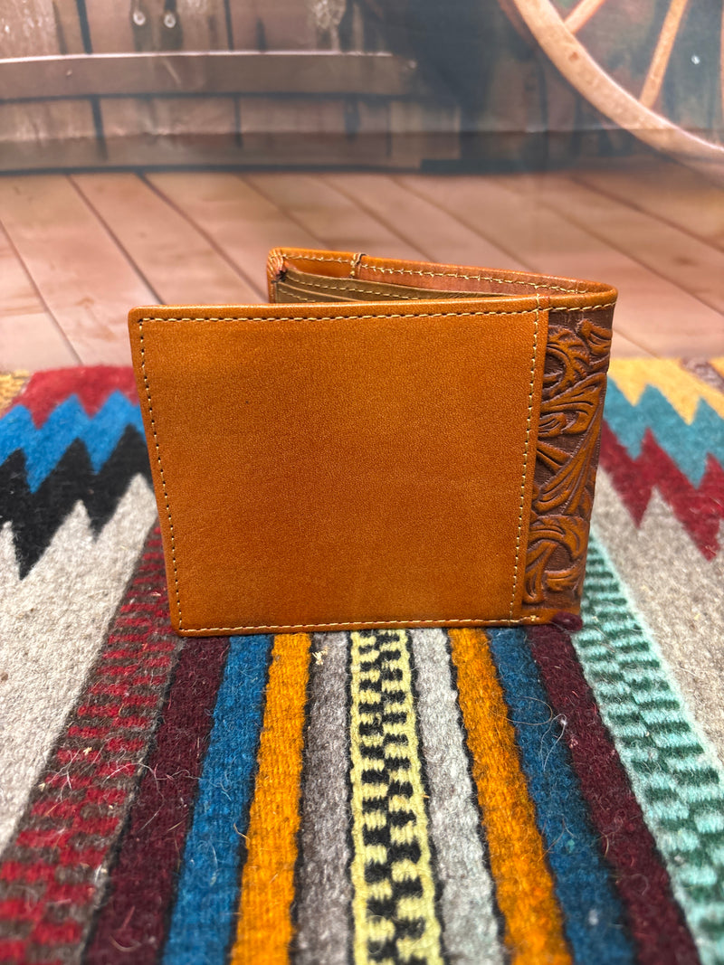 This Brown leather bifold wallet features a embossed Praying Cowboy design and a beige inlay under a tooled pattern. Rear view showing a additional storage spot. 