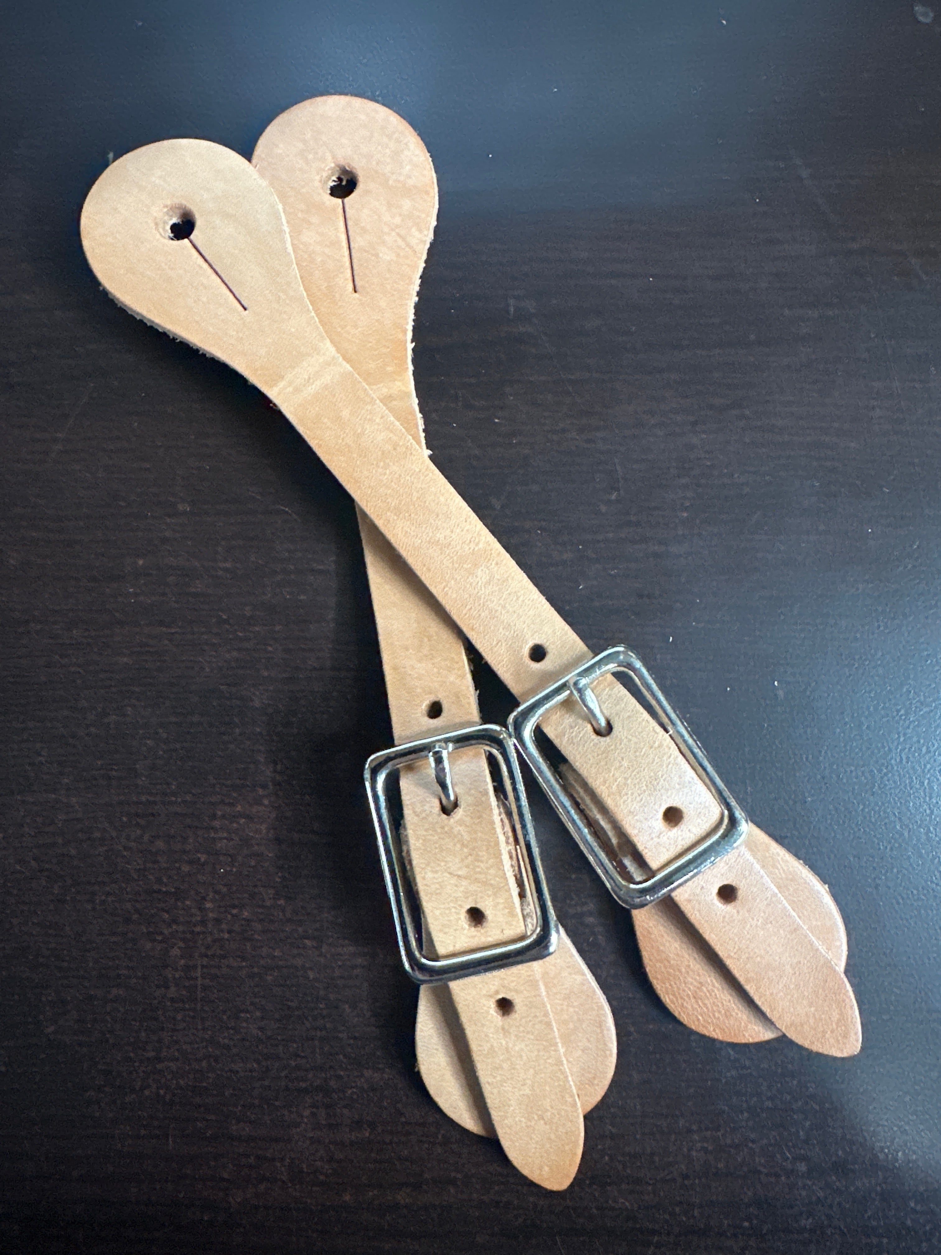 Women's natural leather spur straps. 