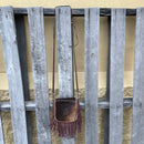 This cowhide and fringe crossbody bag in Coffee Brown leather has a removable and adjustable strap. Full view showing entire length of shoulder strap. 