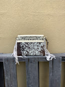 This cowhide and tooled leather crossbody bag features fringe sides and zips closed. The strap is removable and adjustable. Front View A