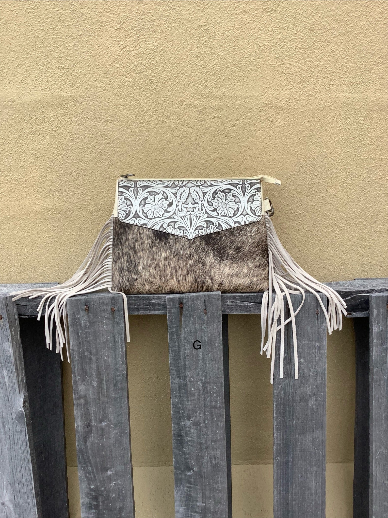 Beige tooled leather and cowhide purse with fringe details and a zippered closure. Front View G