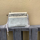 This cowhide and tooled leather crossbody bag features fringe sides and zips closed. The strap is removable and adjustable.  Front View D