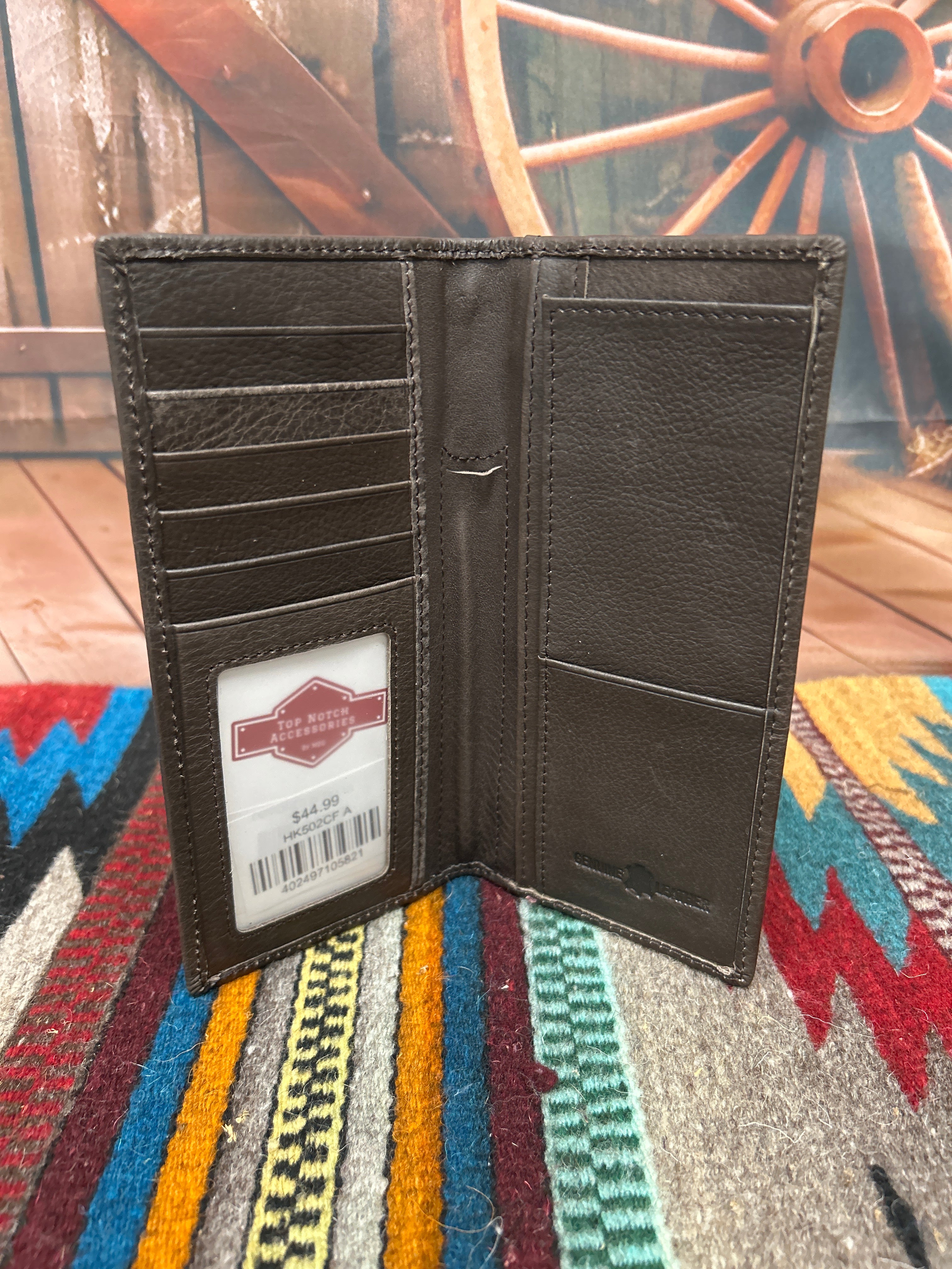 This Coffee Brown basketweave leather checkbook wallet features a Praying Cowboy Concho on a Hair- On corner. Inside view showing multiple card slots, a ID window, checkbook slot, and a pen slot. 